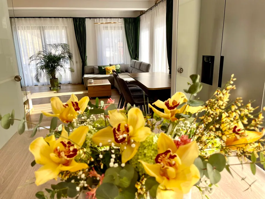 Spring living room with yellow orchid bouquets — floral arrangement